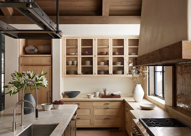 Neutral toned kitchen with chicken wire cabinets. Photo by Instagram user @twilliamsphoto