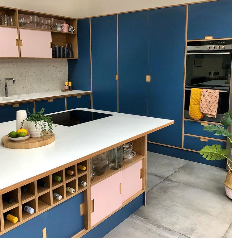 Blue and pink cabinets with white countertops. Photo by Instagram user @catrin.stuart