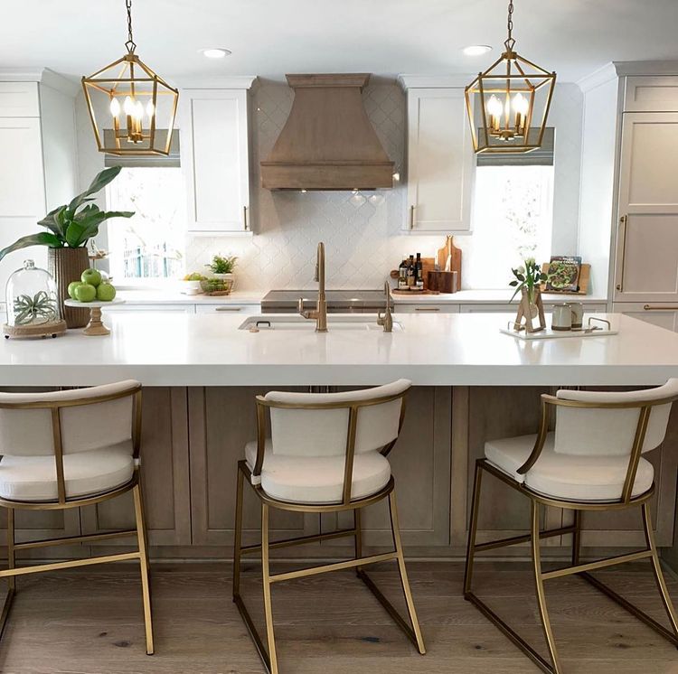 Kitchen island bar with bar stools and overhead lighting. Photo by Instagram user @nestingplaceinteriors