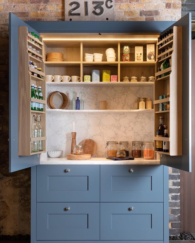 Blue cabinet with internal spice racks. Photo by Instagram user @life_kitchens