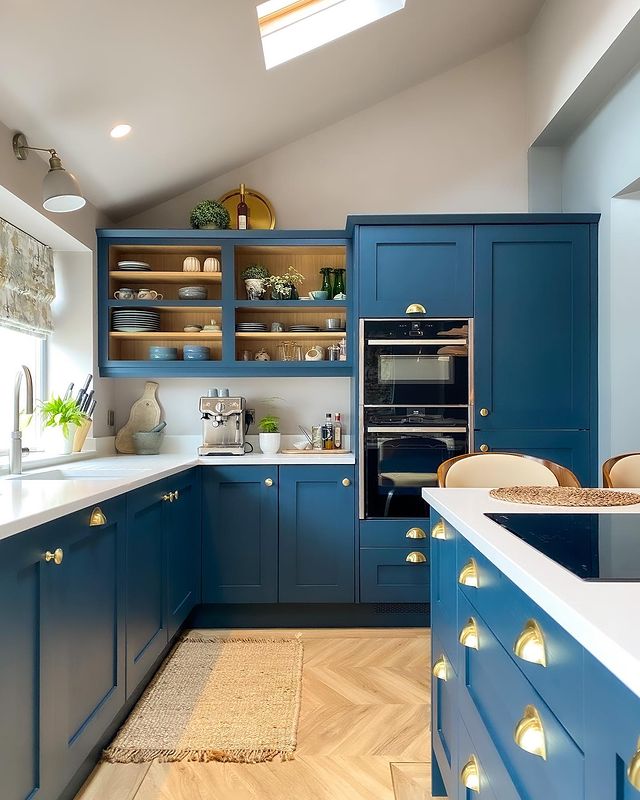 Blue cabinets with open shelving and gold handles. Photo by Instagram user @somethingbluehome