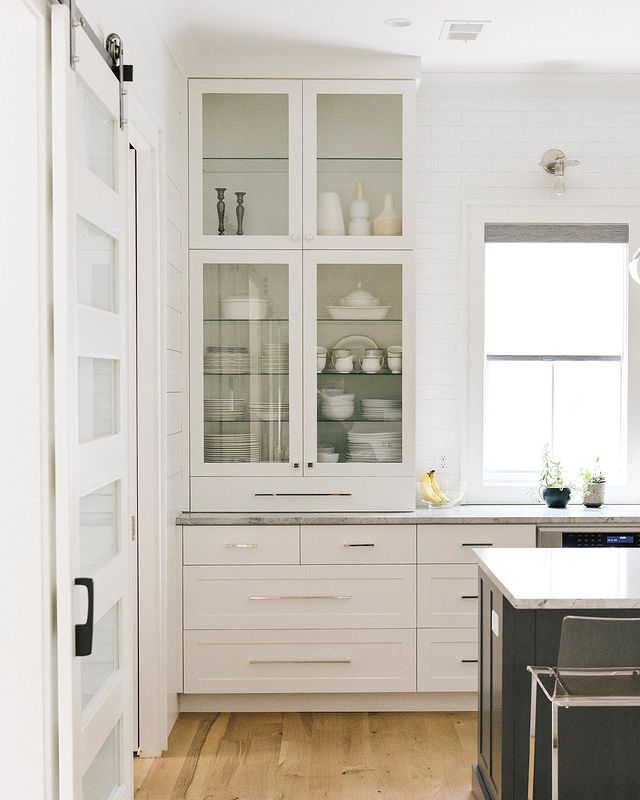 White cabinets with china in glass paned cabinets. Photo by Instagram user @fultonneighborhood