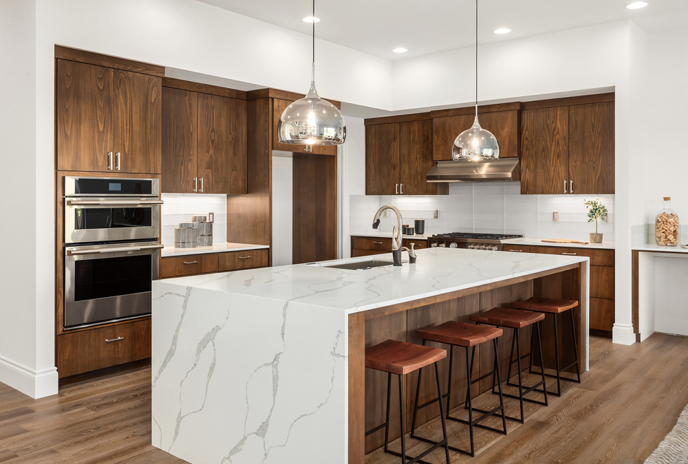 Dark wood cabinets and white marble countertops in a kitchen
