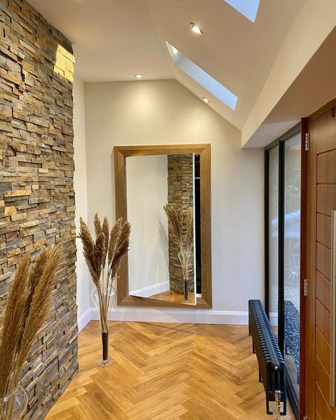 Modern entryway leading to a hidden room concealed by a mirror