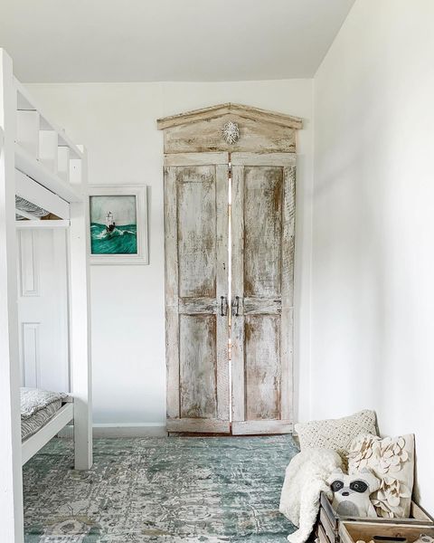 Rustic bedroom with a wardrobe leading into a hidden room