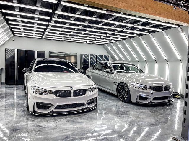Two luxury cars inside a garage surrounded by decorative LED lighting. Photo by Instagram user @money612