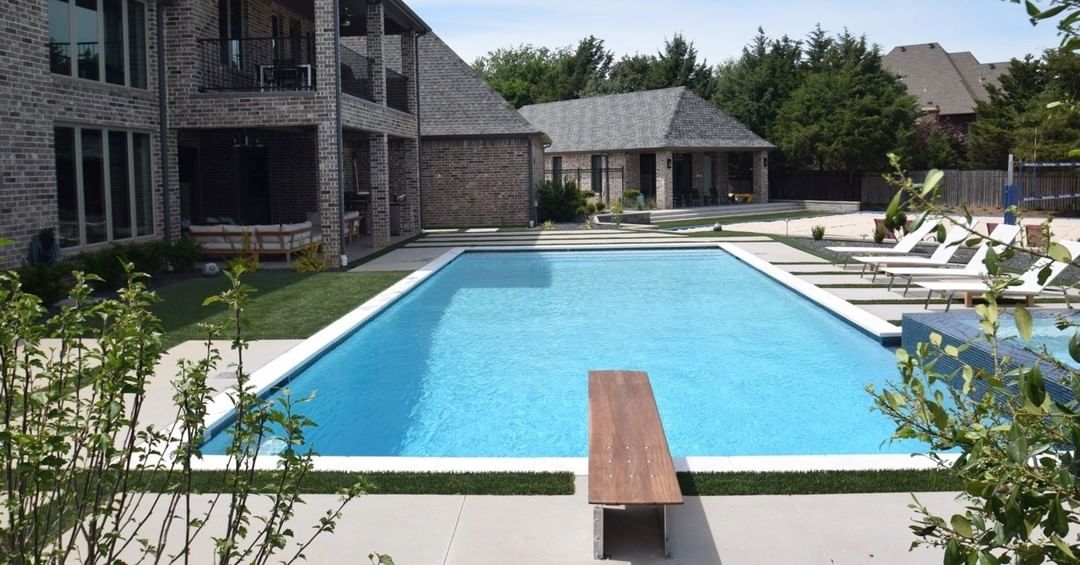 large backyard pool with wooden diving board. Photo via Instagram user @mikel_tube