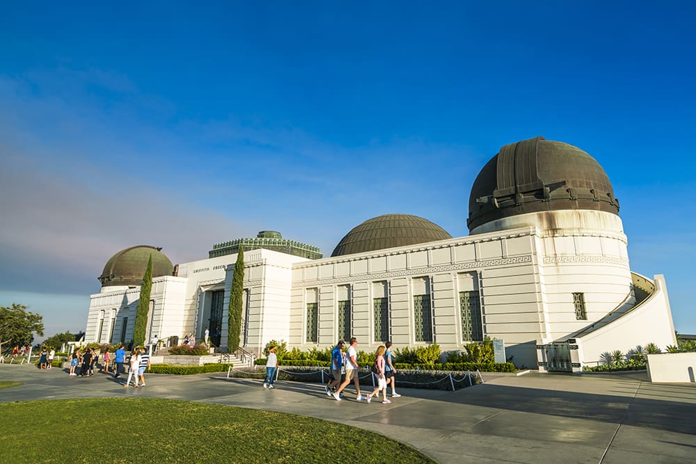 Tourists walking in front of the Griffith Observatory building