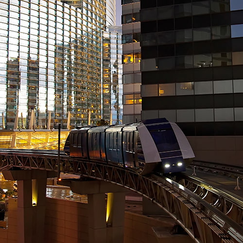 Las Vegas monorail rides between skyscrapers at dusk