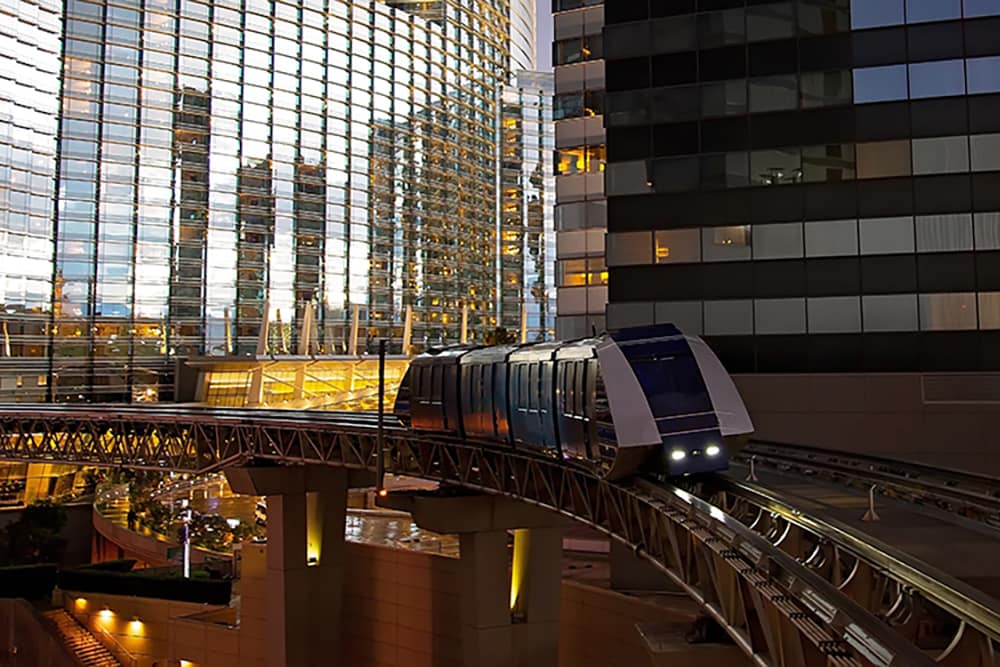 Las Vegas monorail between skyscrapers at dusk