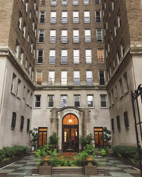 Interior courtyard of a luxury apartment building with brick and stone architecture. Photo via Instagram user @renata.michelle