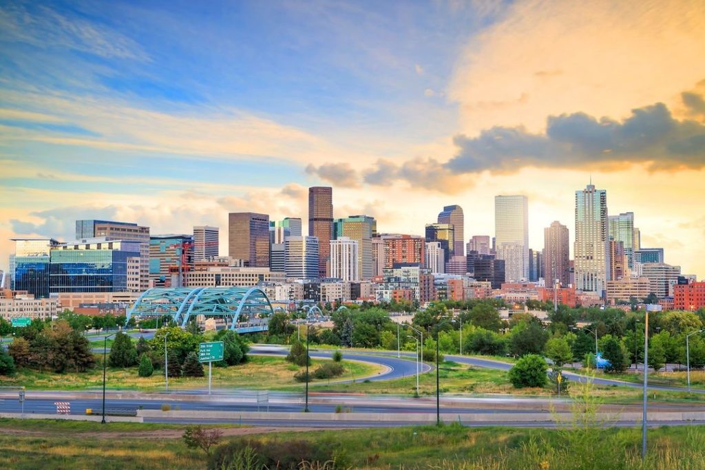 A skyline shot of Denver Colorado on a blue-skied, sunny day. Photo via Instagram user @presidentialworldwide