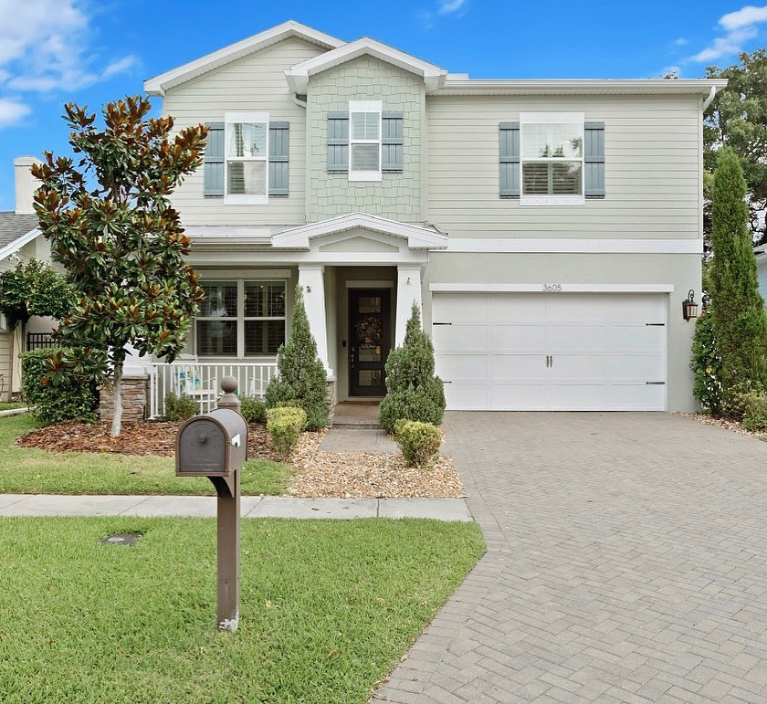 Sage green home with a stone driveway. Photo by Instagram user @erinbunkerealestate