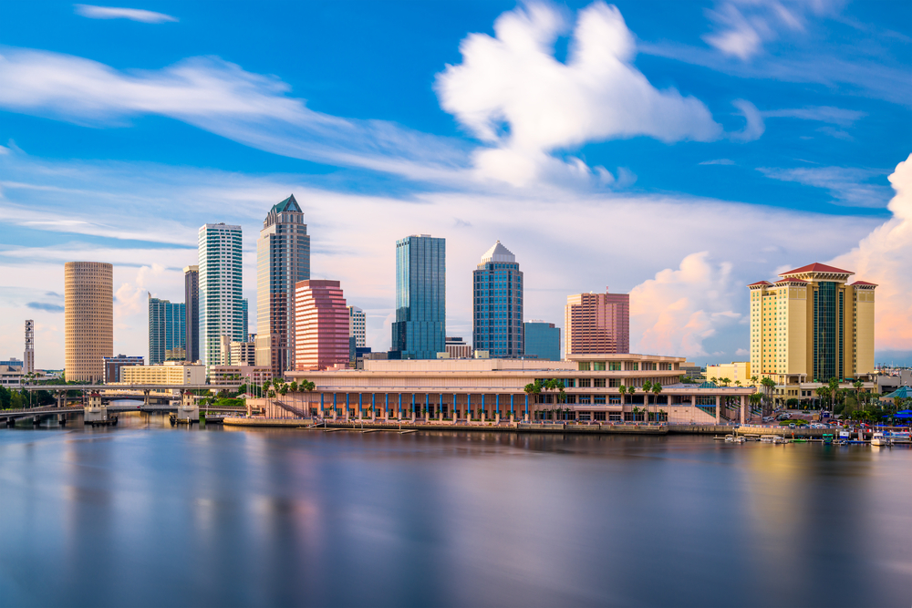 View of the Tampa skyline at mid-day with clouds and shoreline.