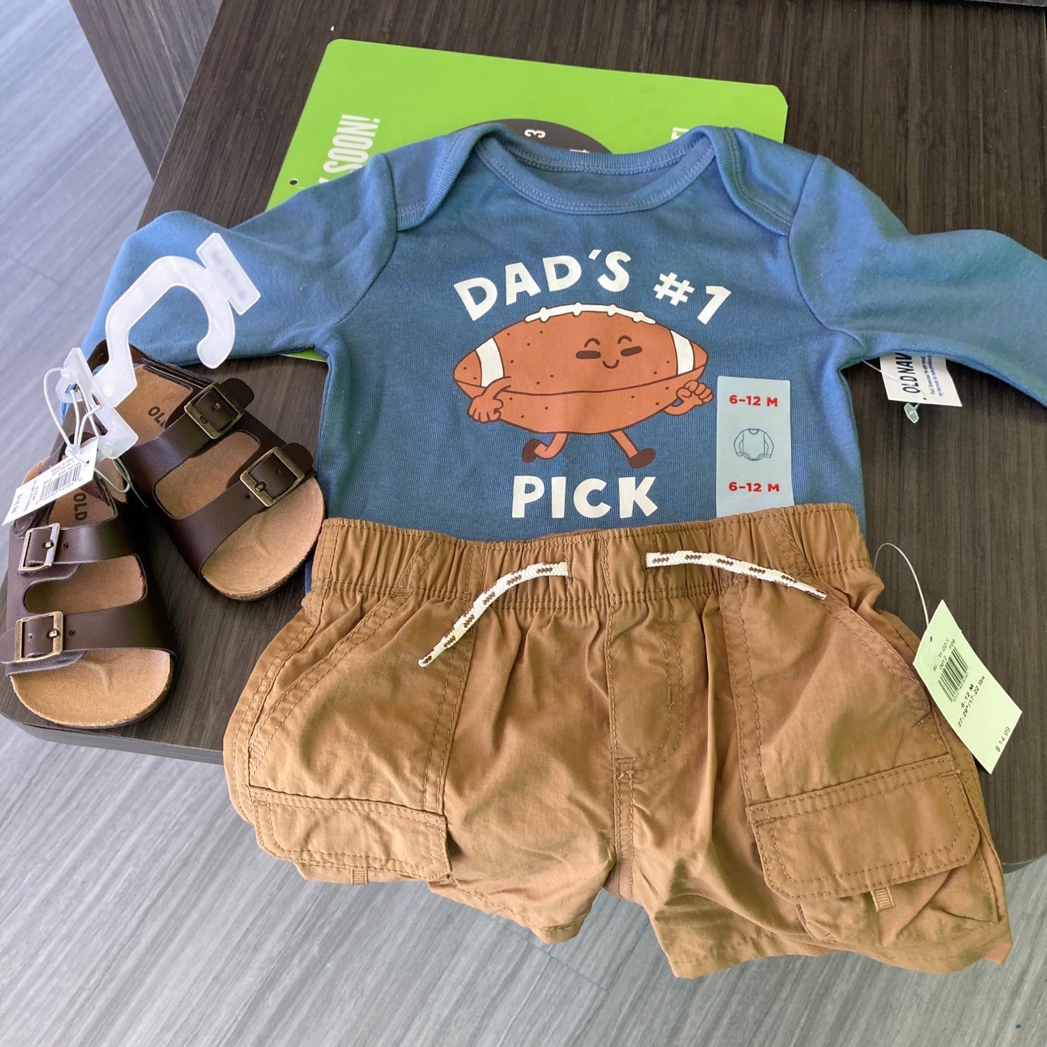 EXR customer appreciation baby gift. Baby outfit, shoes, and a card