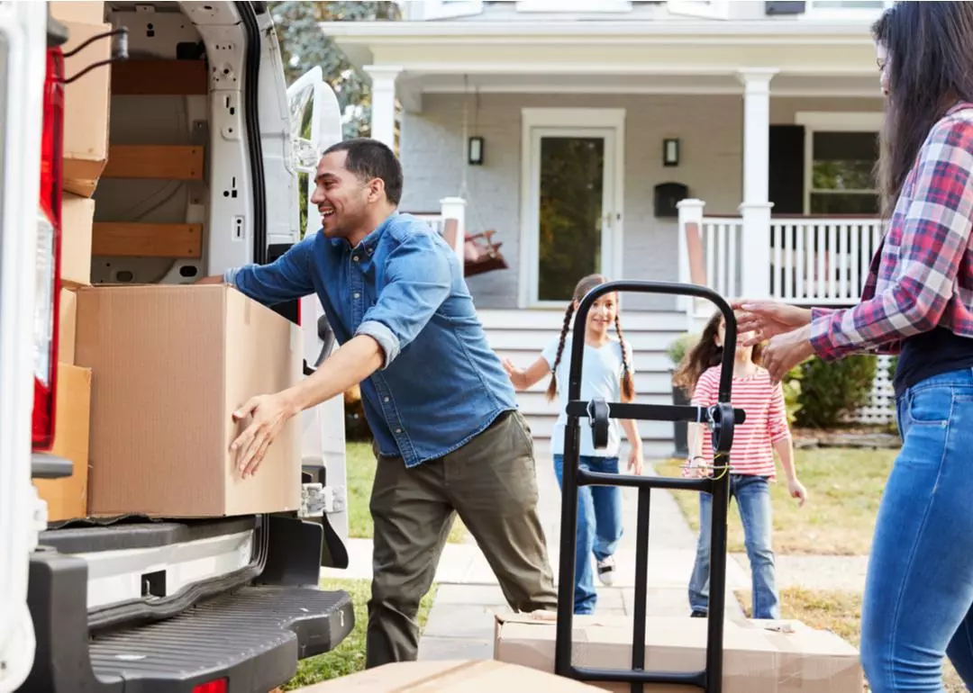 Man moving box into back of open moving truck