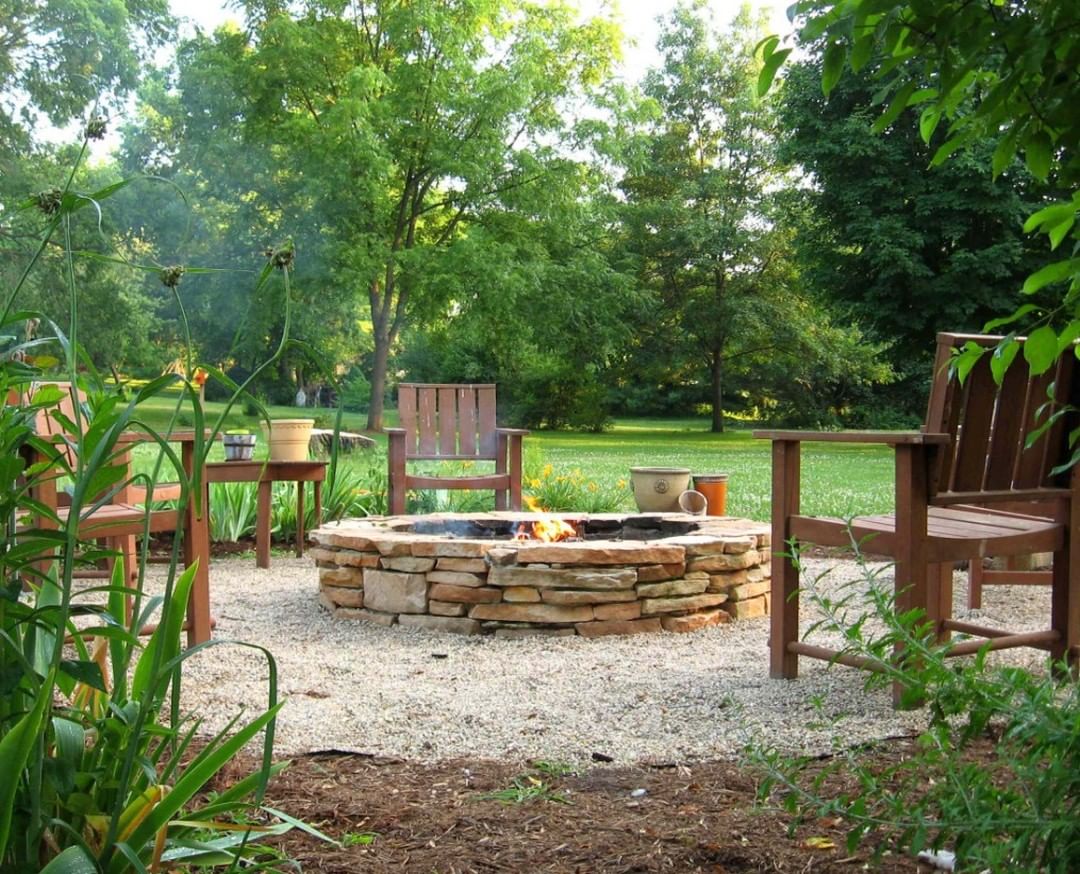 stone fire pit with brown chairs 