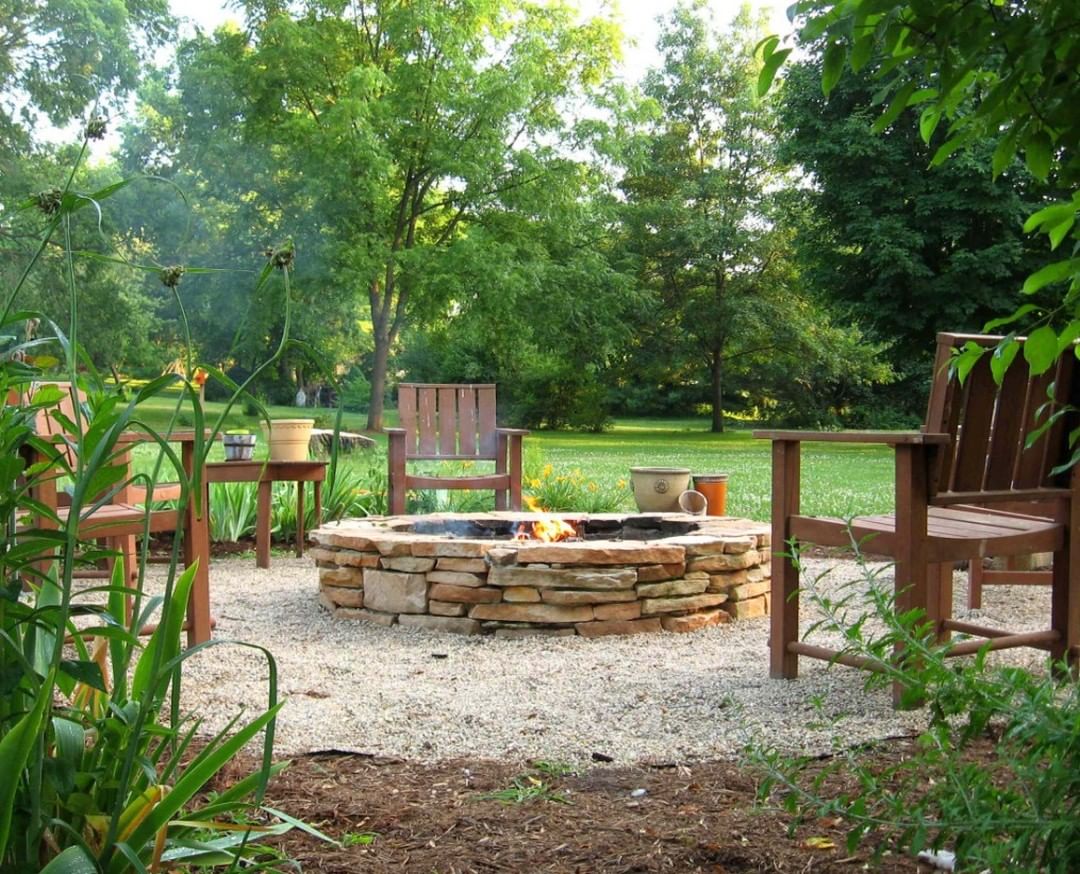 stone fire pit with brown chairs