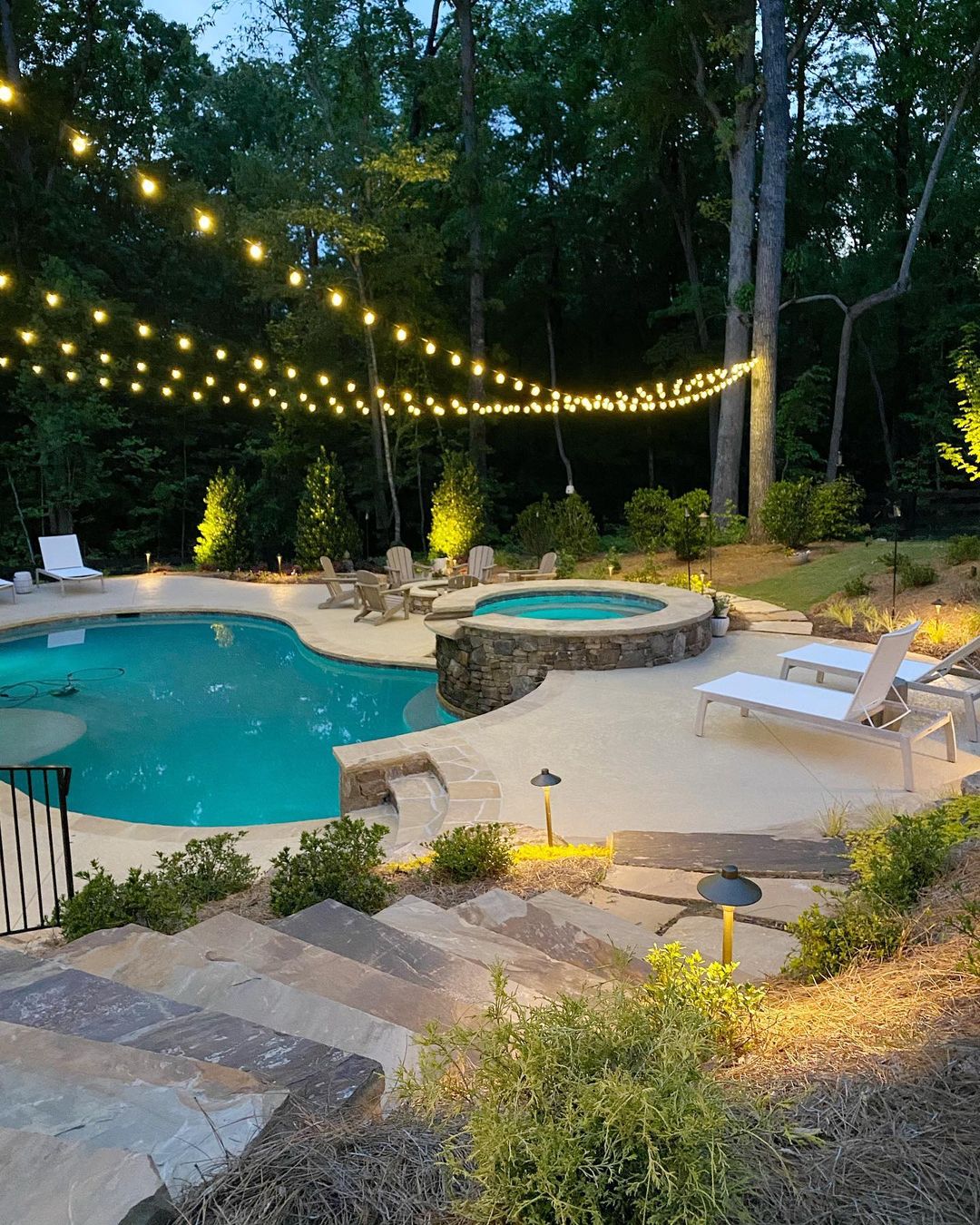 Evening photo of backyard pool with layered string lighting. Photo by Instagram user @geralyn_brennan