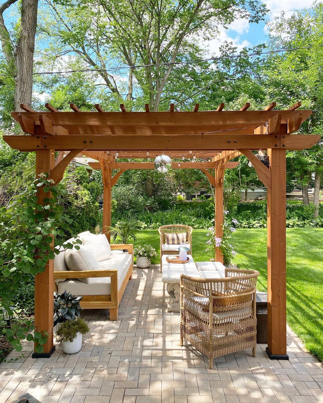 A gazebo in the backyard with white patio furniture. Photo by Instagram user @heyjerry_home