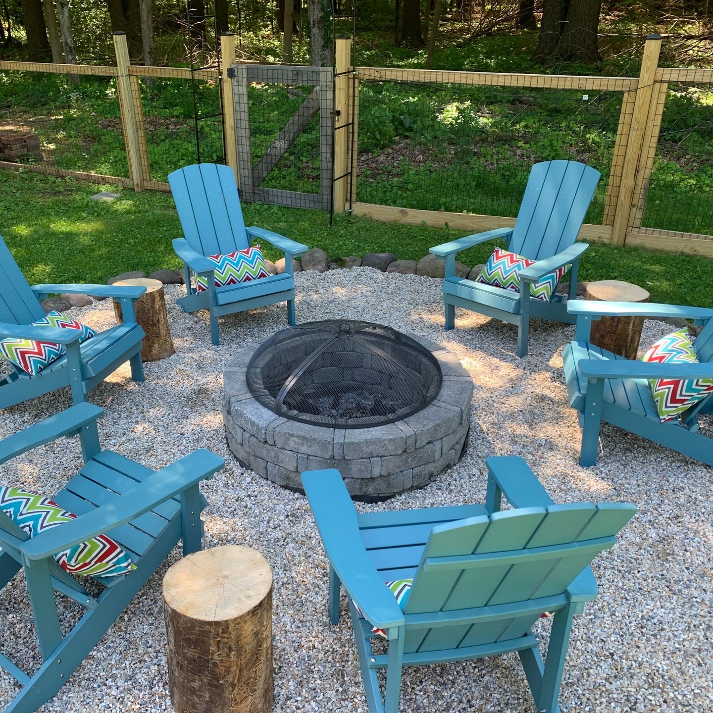 fire pit with blue chairs