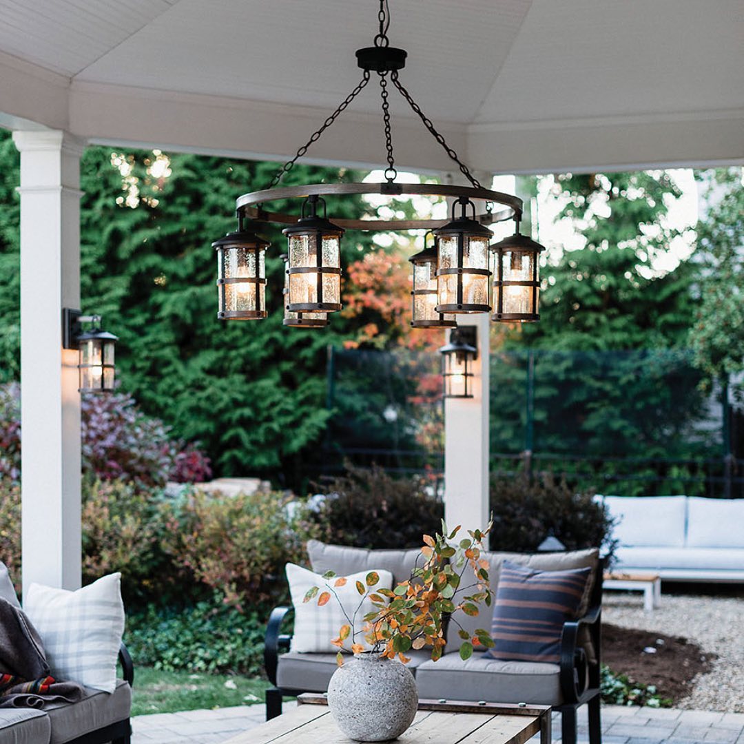 An image of a backyard patio with the focus on the activated chandeliers. @globelighting.