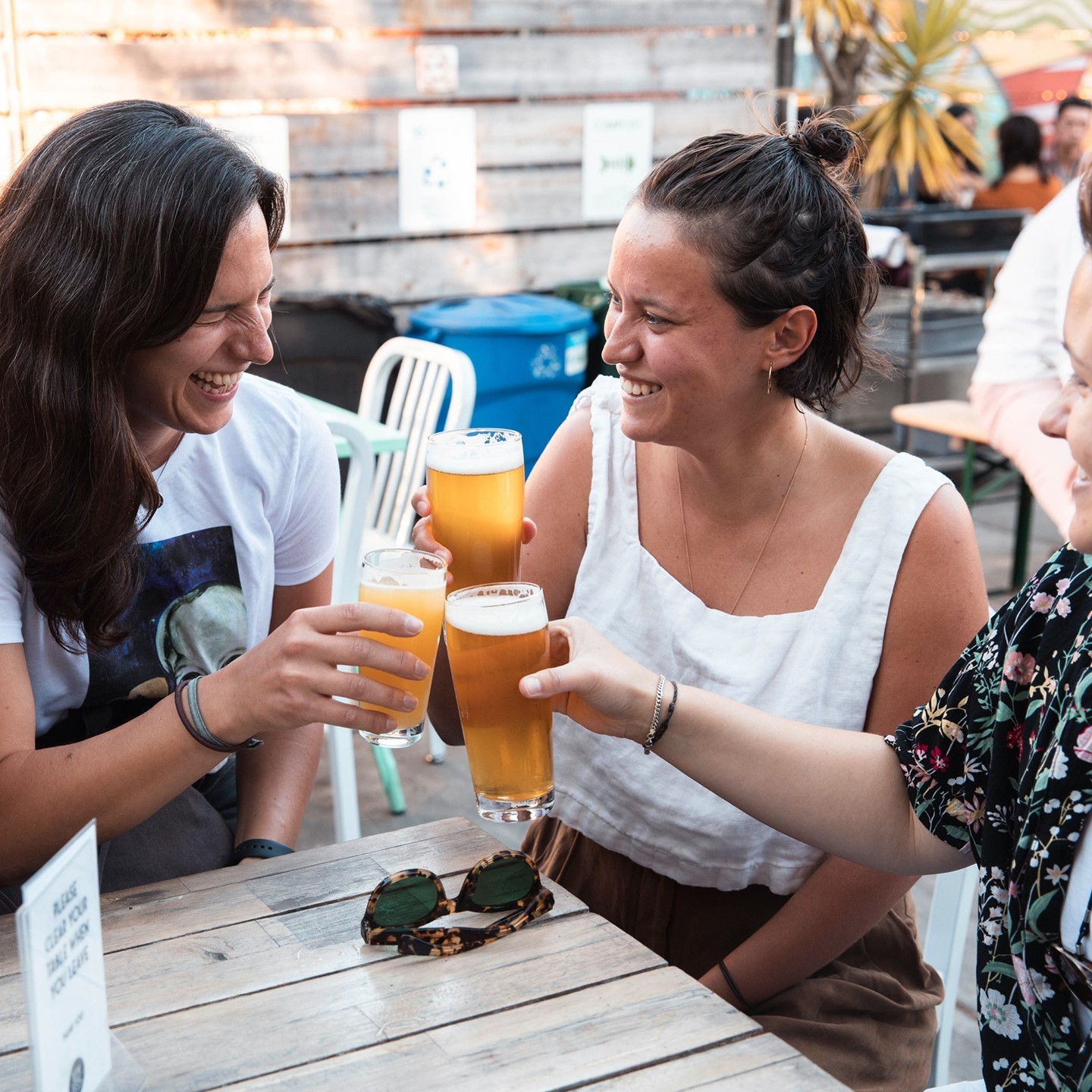 Three women raising their beer glasses for a cheer. Photo by Instagram username @temescalbeer