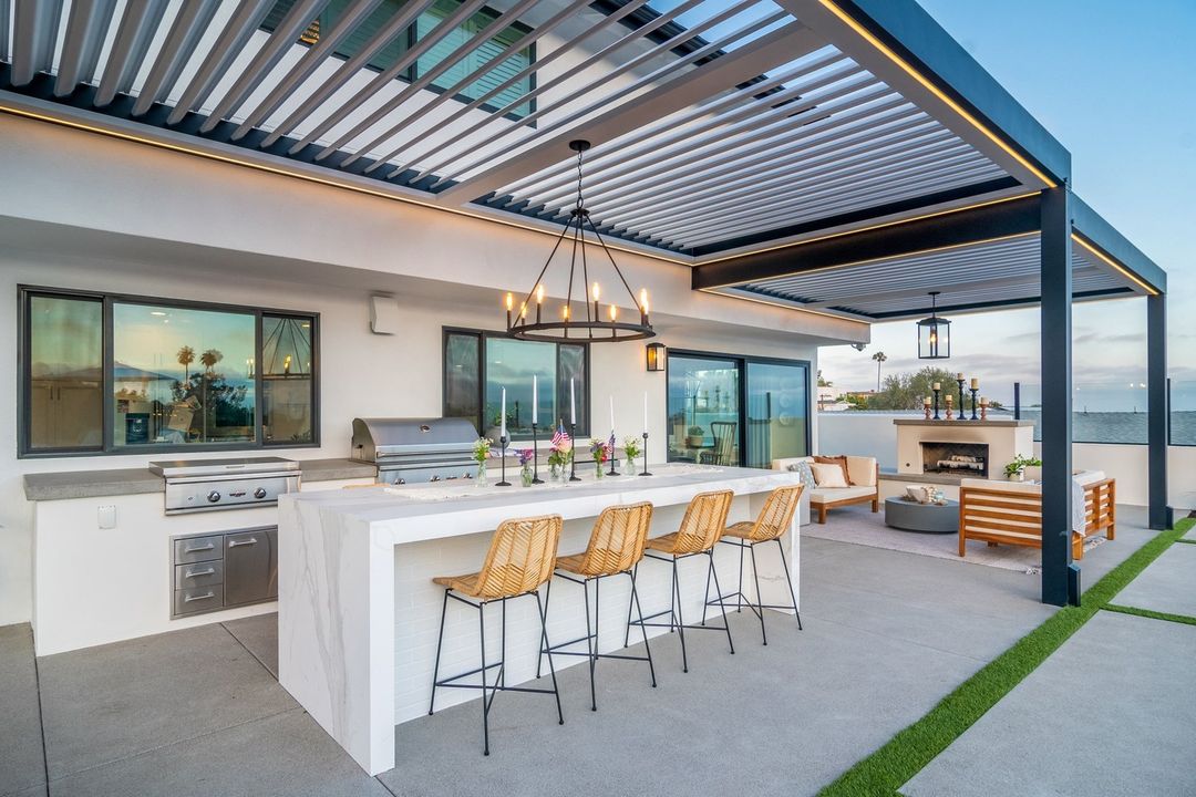 A backyard patio with an island and outdoor kitchen. Photo by Instagram user @outdoorelementsusa