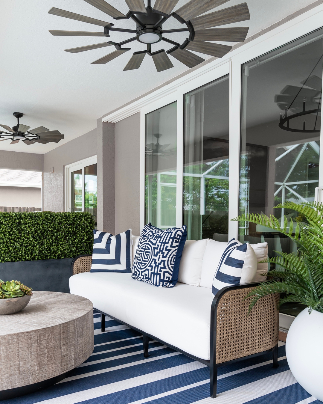 A covered backyard patio decorated with neutral colors. Photo by Instagram user @islandhome_interiors