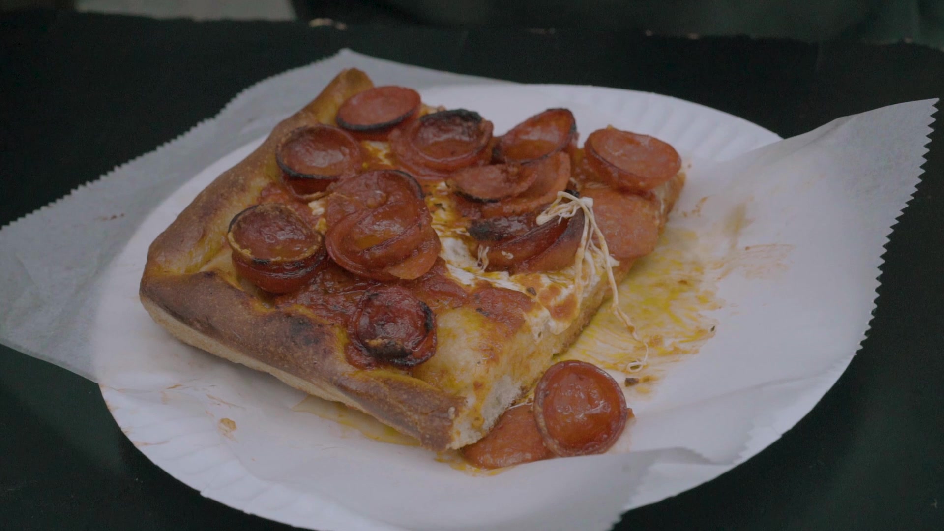 Frame of pepperoni pizza slice from Extra Space Storage's Local Places & Extraordinary Spaces video series