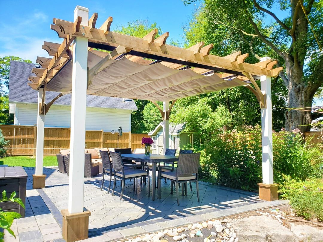 A retractable cloth canopy over a patio seating area. Photo by Instagram user @outdoorlivingtoday.