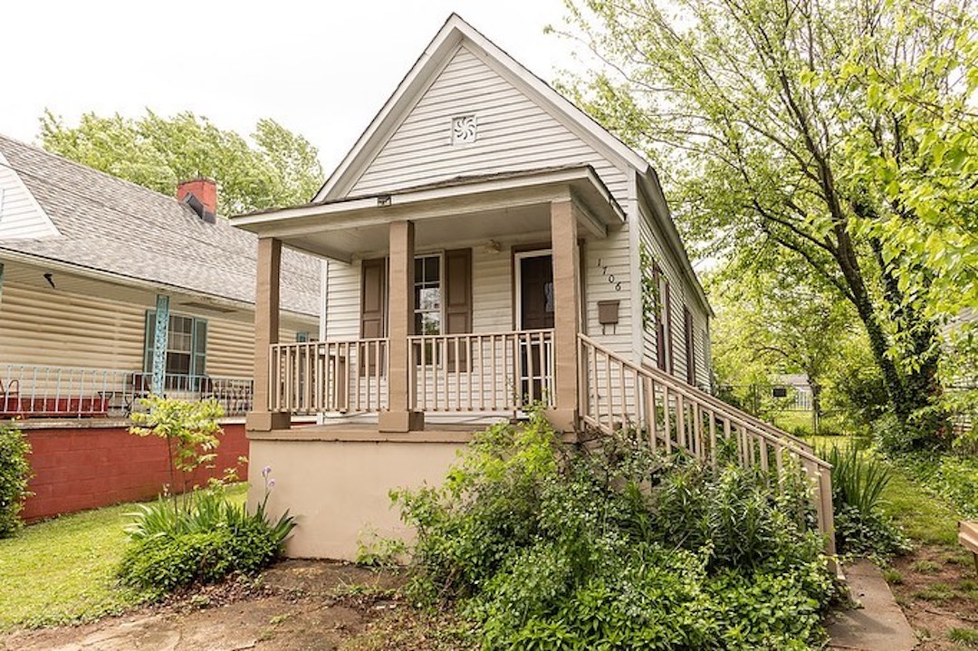Beige bungalow with wooden columns in Downtown Knoxville. Photo by Instagram user @atkinshomegroup