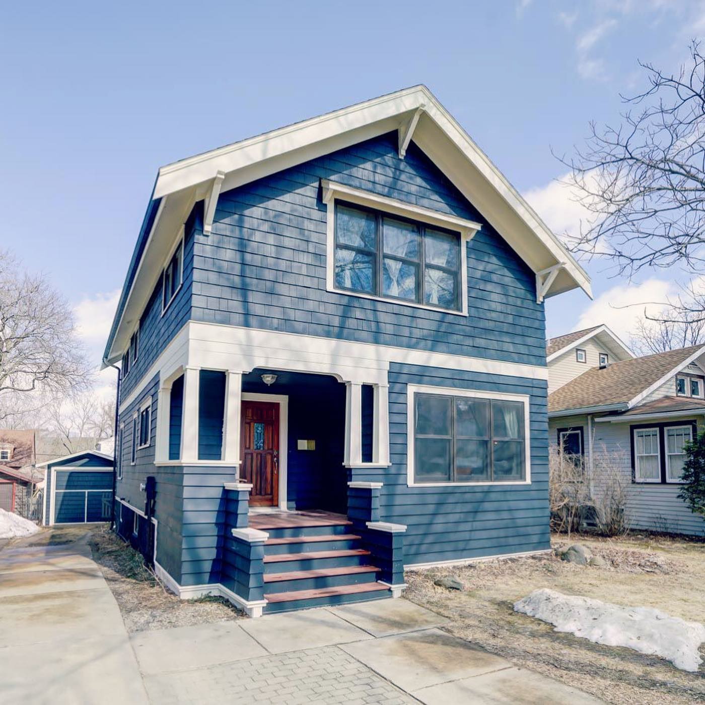 Light blue two-story Craftsman house in Dudgeon-Monroe, Madison. Photo by Instagram username @jessicaosieckirealtor