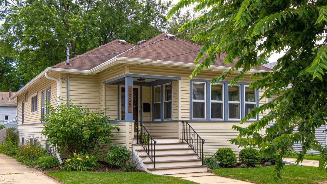 Beige bungalow with blue-lined windows in Marquette, Madison. Photo by Instagram username @spencerrealestategroup