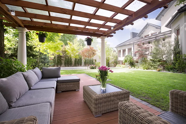 Furnished patio with covered awning and green backyard in background 