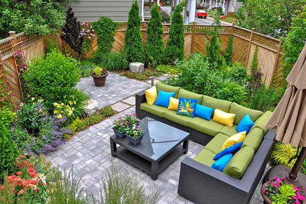Aerial shot of eco-friendly backyard garden with patio furniture 