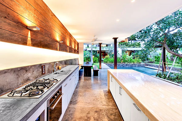 Brightly lit outdoor kitchen with stove and long counters