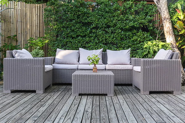 Gray patio furniture on a wooden deck