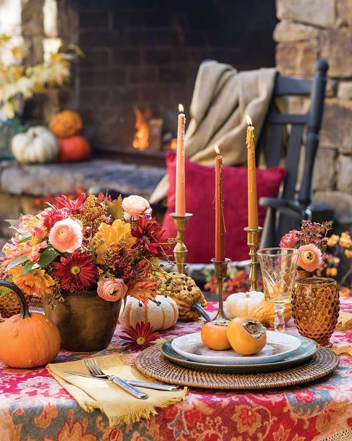 Fall-themed table setting with an autumnal bouquet sitting behind the plate. Photo by Instagram user @thecottagejournal.