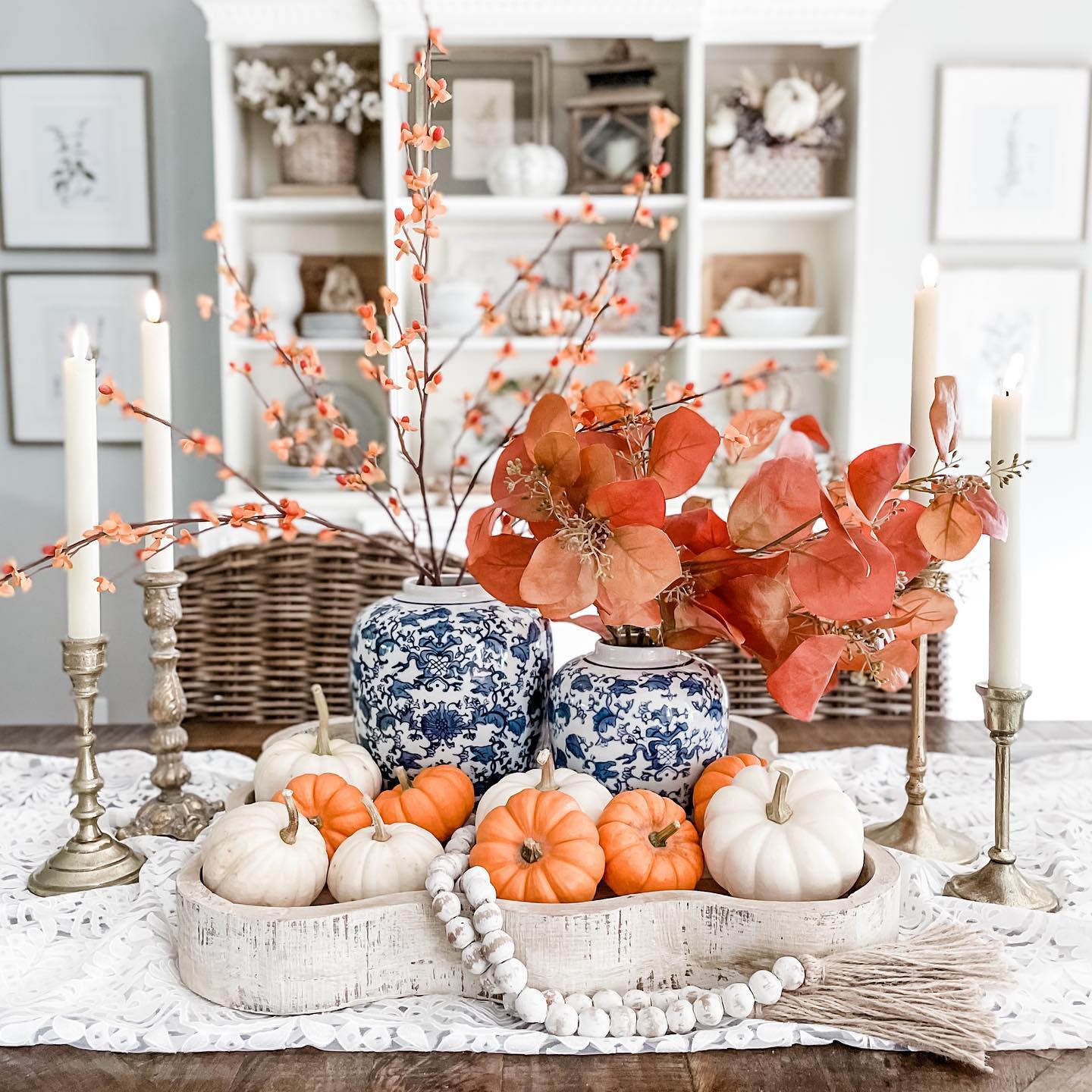 Fall centerpiece with pumpkins, candles, and fall foliage. Photo by Instagram user @bloom_jennybrooks. 