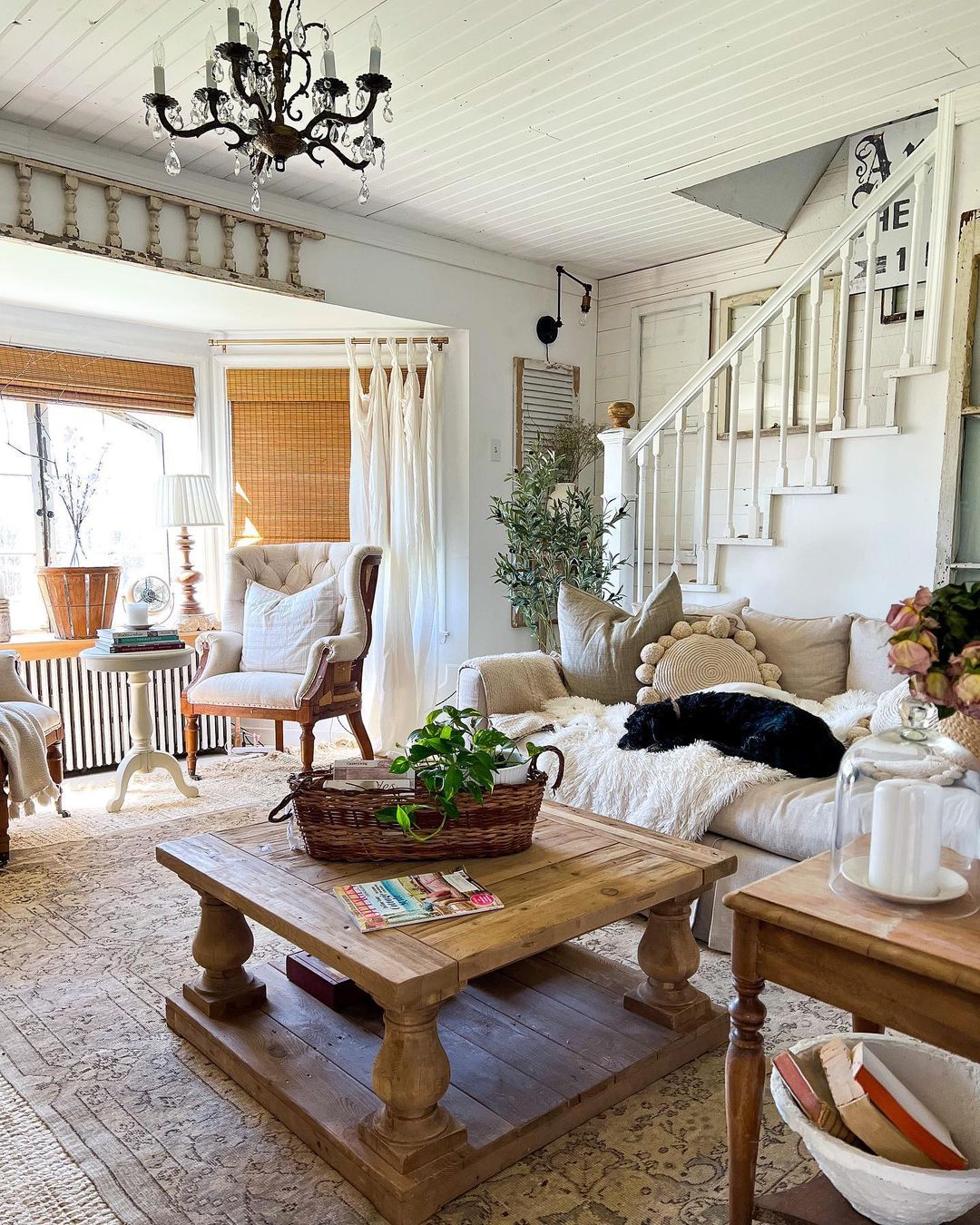 Living area with seating, blankets, and coffee table. Photo by Instagram user @cottageonmainst