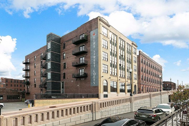 The stone and brick face of the historic Fire Street Lofts building, seen from an angle. Photo by Instagram user @knoxvillehomesrealtor.