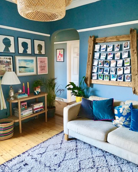 A light blue room with various things hanging on the walls.