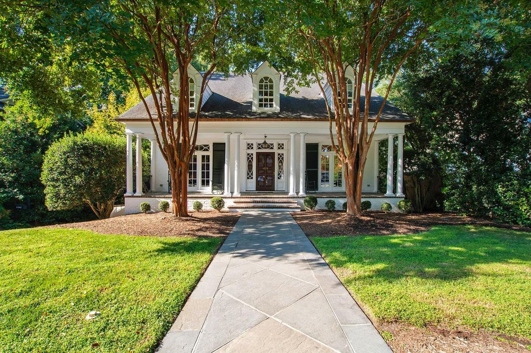 Home in Five Points, Raleigh with two trees and a sidewalk in the middle. Photo by Instagram user @mollieowen_hodgekittrellsir.