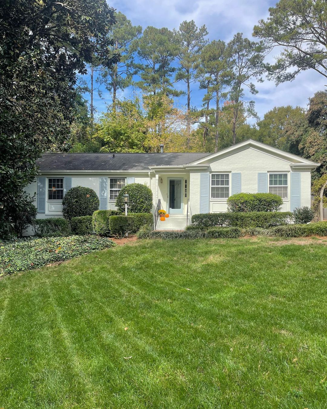 A ranch style home in North Hills, Raleigh with a large manicured lawn. Photo by Instagram user @kathleendlalor.realtor.