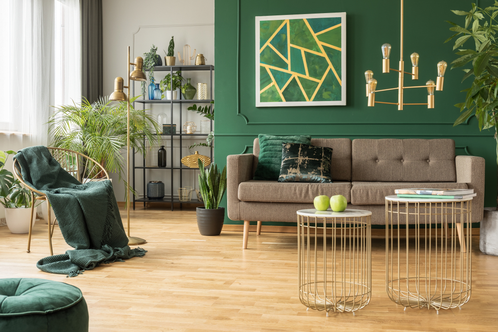 A green painted room with furniture to complement the well lit space
