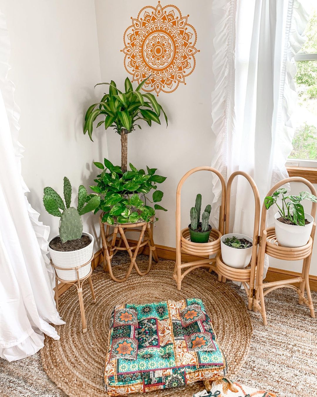 Meditation corner with potted plants and a white curtain over the walls. Photo by Instagram user @chloe_xandria