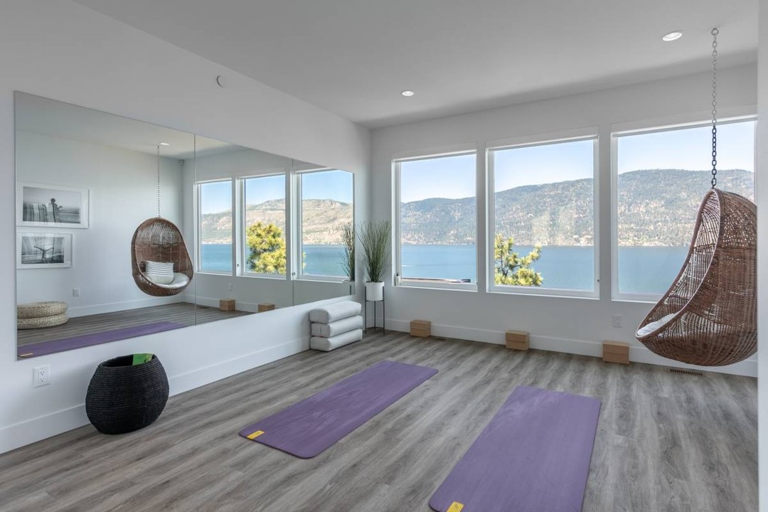 Zen room with wall mirrors, two yoga mats, and large windows. Photo by Instagram user @bellamyhomes