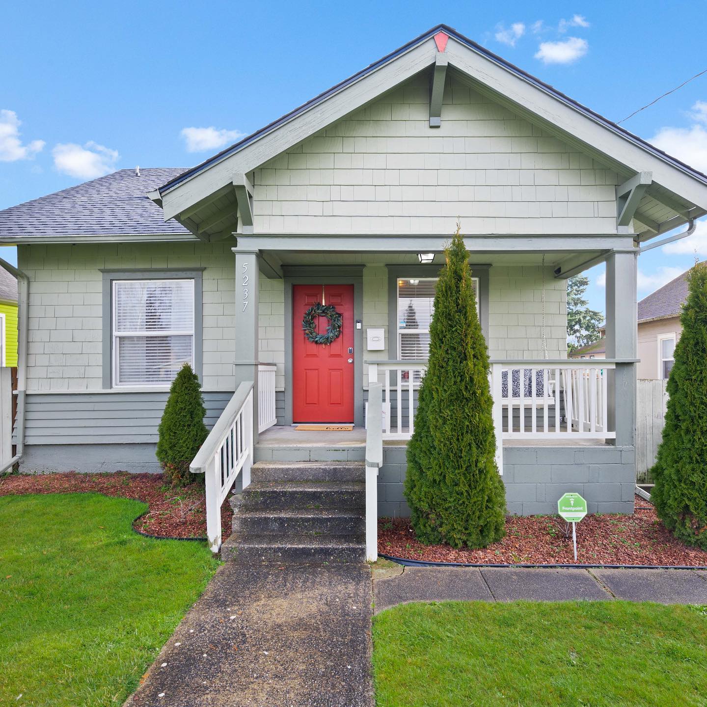 Classic craftsman home with a red door is pictured in the New Tacoma neighborhood. Photo by Instagram user @cristinarosshomes.