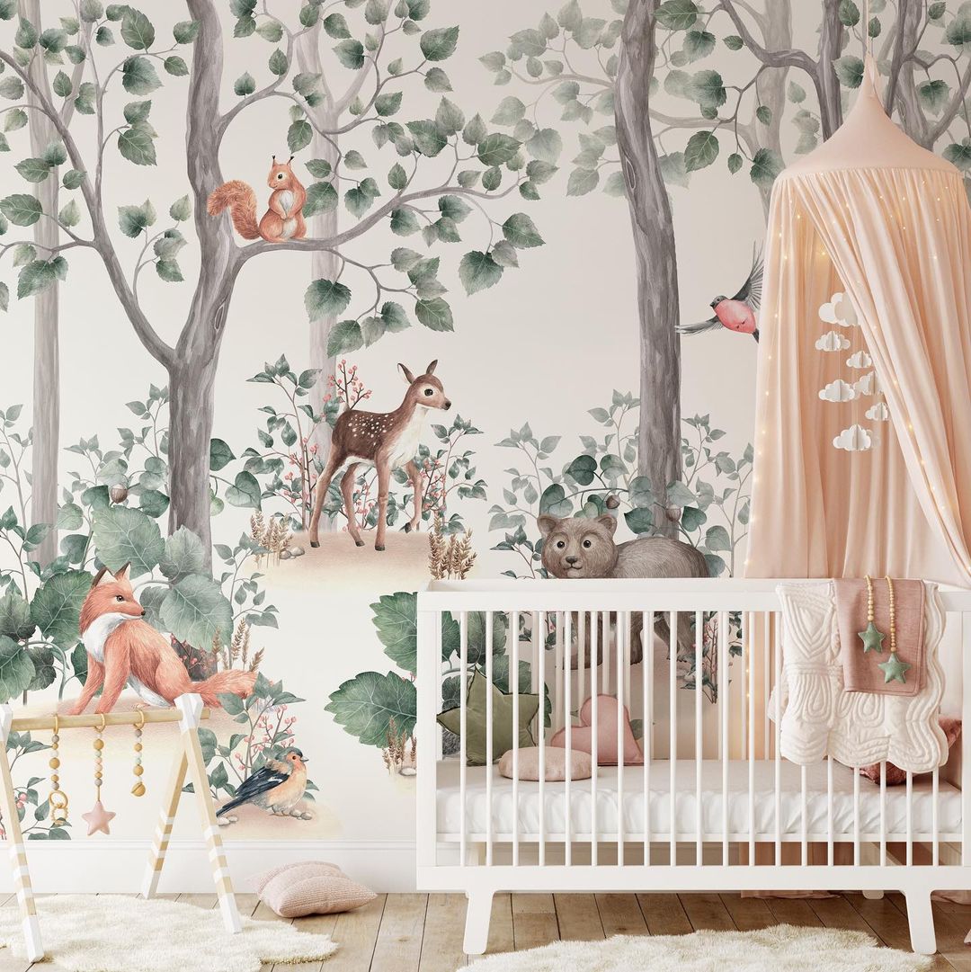 Nursery with forrest themed wallpaper. Photo by Instagram user @wunderwallmural